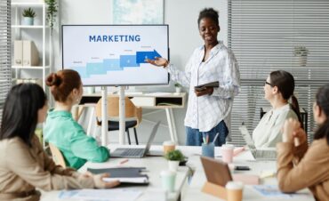 Presentación de estrategia de marketing digital en equipo, con gráfica de planificación en pantalla.